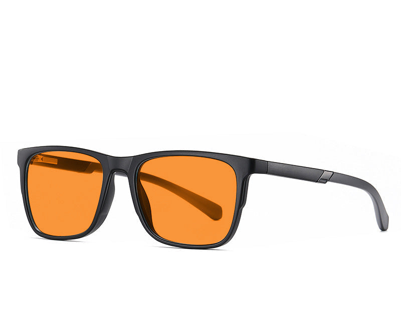 Blue light glasses with orange lenses and black frame on a white background.